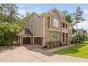 Charming side view showcasing the home's architectural details and attached three-car garage at 728 Peninsula Forest Pl, Cary, NC 27519