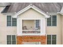 A close-up of a condo balcony with chairs that offers a cozy outdoor retreat at 734 Portstewart Dr, Cary, NC 27519