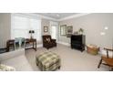 Well-lit living room with neutral colors, crown molding, and multiple windows for abundant natural light at 734 Portstewart Dr, Cary, NC 27519