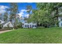 Well-kept two-story home with a lush lawn and mature trees in a desirable neighborhood at 7917 Featherstone Dr, Raleigh, NC 27615