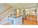 Open kitchen features light wood cabinets, stainless appliances and island with seating and extra storage at 875 Martin Luther King Jr Blvd # 7, Chapel Hill, NC 27514