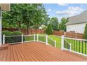 A well maintained backyard deck with a manicured lawn and a wood fence at 10012 San Remo Pl, Wake Forest, NC 27587