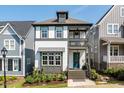 Inviting two-story home features a front porch, second-story balcony, and meticulously landscaped front yard at 1008 Whistler St, Durham, NC 27713