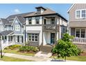 Attractive two-story home with a charming covered porch and a second-story balcony, complemented by lush landscaping at 1008 Whistler St, Durham, NC 27713