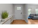 Bright foyer with wood floors, white trim, and view of the living room at 101 Joel Ct, Cary, NC 27513