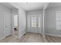Bright foyer features decorative glass front door and neutral paint, creating an inviting entrance to the home at 1013 Sagamore Dr, Louisburg, NC 27549