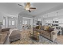 Open-concept living room showcases a modern design with light gray walls and seamless flow to the dining and kitchen areas at 1013 Sagamore Dr, Louisburg, NC 27549