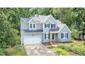 Beautiful two-story home with an attached two-car garage and manicured front yard landscaping at 107 E Seve Ct, Morrisville, NC 27560