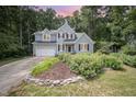 Well-maintained two-story home featuring a lush, landscaped front yard and attached two-car garage at 107 E Seve Ct, Morrisville, NC 27560