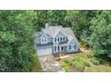 Charming two-story home featuring a lush, landscaped front yard and attached two-car garage at 107 E Seve Ct, Morrisville, NC 27560