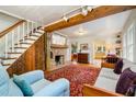 Bright living room featuring a brick fireplace, exposed beams, and hardwood floors at 108 High St, Carrboro, NC 27510