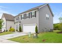 Two-story house with gray siding, black shutters, and a concrete driveway at 120 Misty Grove Trail Trl, Franklinton, NC 27525