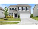 Well-maintained two-story home featuring gray siding, black shutters, and a spacious two-car garage at 120 Misty Grove Trail Trl, Franklinton, NC 27525