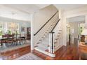 Bright foyer featuring hardwood floors, staircase and decorative millwork throughout at 1313 Duplin Rd, Raleigh, NC 27607
