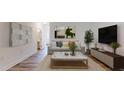 Cozy living room with a comfortable sofa, decorative pillows, and a modern coffee table, adjacent to hall and bathroom at 1365 Scholar Dr, Durham, NC 27703