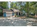 Spacious home with attached garage and a long drive way, surrounded by mature trees at 1426 Kildaire Farm Rd, Cary, NC 27511