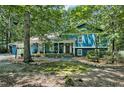 Two-story house showcasing a beautiful lawn with lots of trees on a sunny day at 1426 Kildaire Farm Rd, Cary, NC 27511