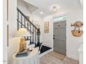 Inviting foyer features a gray front door, elegant staircase with stylish decor and natural light at 1701 Berwickshire Cir, Raleigh, NC 27615