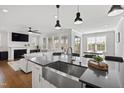 Open-concept living area with recessed lights, island seating, and a view of the fireplace and lounge at 199 High Woods Rdg, Chapel Hill, NC 27517