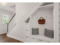 Stylish entryway featuring custom built-ins, storage, and a decorative wall design at 212 Golf Vista Trl, Holly Springs, NC 27540