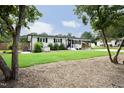 Quaint one-story house with a well-kept lawn, mature trees, and a neutral color scheme at 2320 Marks Creek Rd, Knightdale, NC 27545