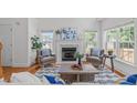 Inviting living room featuring a cozy fireplace, plush seating, and natural light at 2575 Primrose Ln, Creedmoor, NC 27522