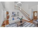 Spacious living room boasting high ceilings, hardwood floors, and a staircase at 2575 Primrose Ln, Creedmoor, NC 27522