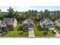 Aerial view of a beautiful two-story home with a well-manicured lawn in a suburban neighborhood at 3032 Curling Creek Drive Dr, Apex, NC 27502