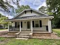Front exterior of a well-maintained one-story home with a cozy covered porch and black accents at 306 Penny St, Garner, NC 27529