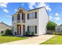 Inviting two-story home with a balcony, manicured lawn, and a spacious driveway at 3101 Riverbrooke Dr, Raleigh, NC 27610