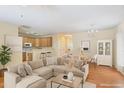 Open-concept living space featuring hardwood floors, neutral walls, and seamlessly connects to the kitchen at 320 Madres Ln, Morrisville, NC 27560