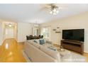 Bright, open-concept living room boasts hardwood floors and a ceiling fan for added comfort at 320 Madres Ln, Morrisville, NC 27560