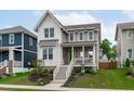Inviting two-story home with a charming porch, steps, and well-maintained lawn and landscaping at 3310 Mission Olive Pl, New Hill, NC 27562