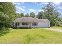 Charming single-story home with a well-manicured lawn and attached garage at 3336 Piney Grove Wilbon Rd, Fuquay Varina, NC 27526