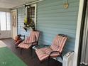 Comfortable seating area on screened-in porch at 3555 Nc 98 Hwy, Youngsville, NC 27596