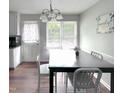 Bright dining room with a large window, contemporary lighting, and a dining table perfect for Gathering meals at 3624 Meadow Creek Ln, Raleigh, NC 27616