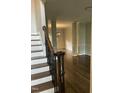 Entryway with dark hardwood floors, staircase, and columns leading into the living spaces at 3811 Cottonwood Dr, Durham, NC 27705