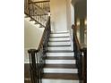 Staircase with wood treads, white risers and dark iron railing leading upstairs at 3811 Cottonwood Dr, Durham, NC 27705
