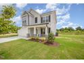 Beautiful two-story home with a well-kept lawn and stone-accented porch columns at 44 Chloe Ct, Selma, NC 27576
