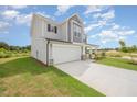 A charming two-story home features a spacious driveway and lush green lawn at 44 Chloe Ct, Selma, NC 27576