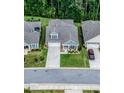 Aerial view of home showcasing its well-manicured lawn, landscaping, and neighborhood setting nestled among mature trees at 440 Bramble Ln, Clayton, NC 27527