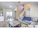Open-concept living area with a fireplace and staircase is perfect for entertaining at 460 Dickens Dr, Raleigh, NC 27610