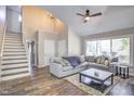 Bright living room with a fireplace, a large sectional couch, and access to a staircase at 460 Dickens Dr, Raleigh, NC 27610