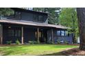 Two-story home with dark brick and siding, complemented by a well-manicured lawn at 4812 Latimer Rd, Raleigh, NC 27609