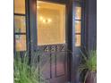 Elegant dark front door with glass panes and decorative house numbers at 4812 Latimer Rd, Raleigh, NC 27609