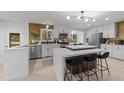 Bright kitchen featuring white cabinets, stainless steel appliances, a large island, and decorative backsplash at 4812 Latimer Rd, Raleigh, NC 27609