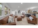Spacious open-concept living room with leather seating and views into the kitchen and staircase at 4812 Latimer Rd, Raleigh, NC 27609