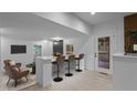 Open living room features a bar with seating, seamlessly connecting the spaces at 4812 Latimer Rd, Raleigh, NC 27609