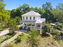 Expansive two-story house with a large porch surrounded by lush landscaping and trees at 508 N Wake St, Hillsborough, NC 27278