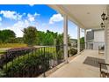 Relaxing covered porch with railing and a view of the front yard and landscaping at 52 Summit Overlook Dr, Clayton, NC 27527